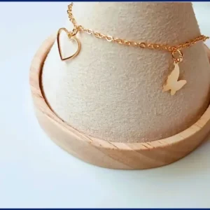 Charm bracelet with a butterfly and a heart pendan